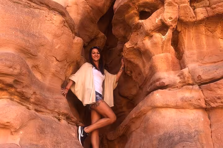 Traveler posing in Salama Canyon sandstone passage on Jeep safari from Sharm El Sheikh to Dahab
