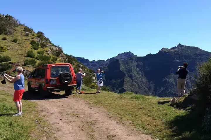 Tourists enjoy breathtaking mountain views on a Jeep tour in Câmara de Lobos, capturing the scenic Madeira landscape.