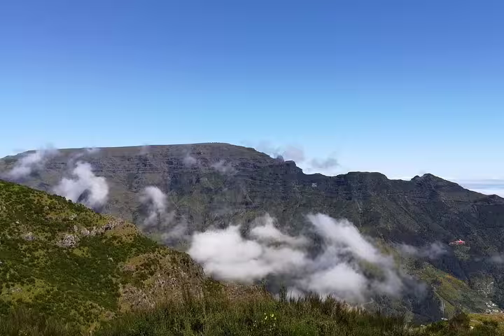 Stunning mountain vistas and floating clouds captured during a Jeep Tour in Câmara de Lobos, Madeira.