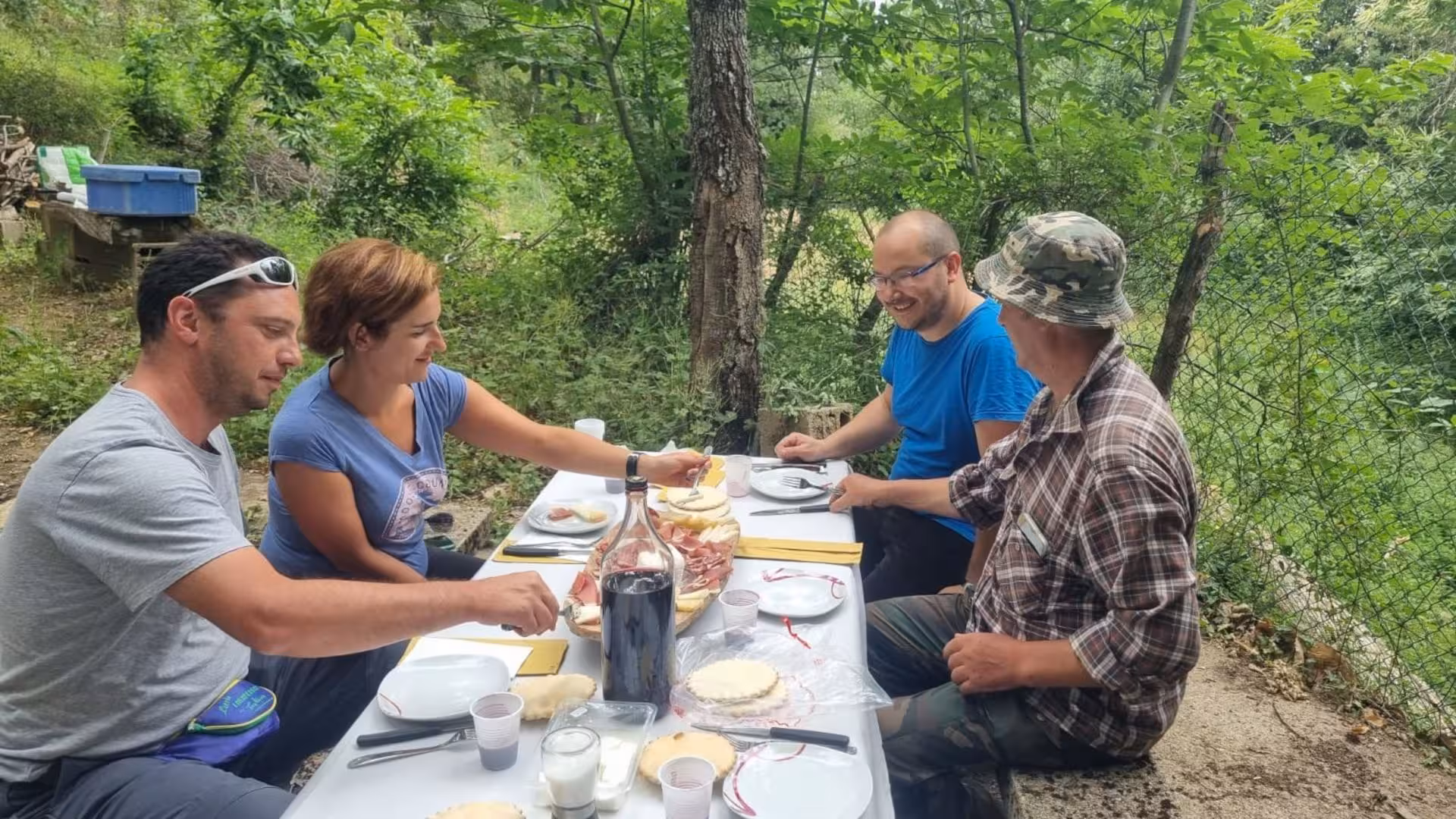 Travelers enjoying a traditional lunch with a local shepherd in the lush Barbagia region.