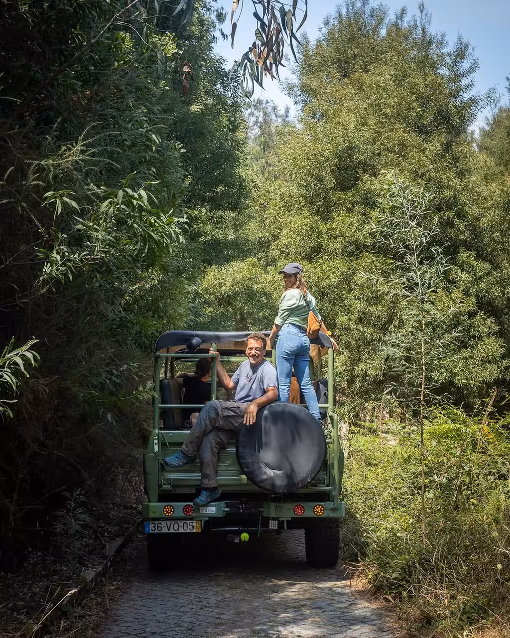 Open-air jeep drives through lush woodland on Jeeptour Nature Hiking and Yoga Class, eco nature tour transport