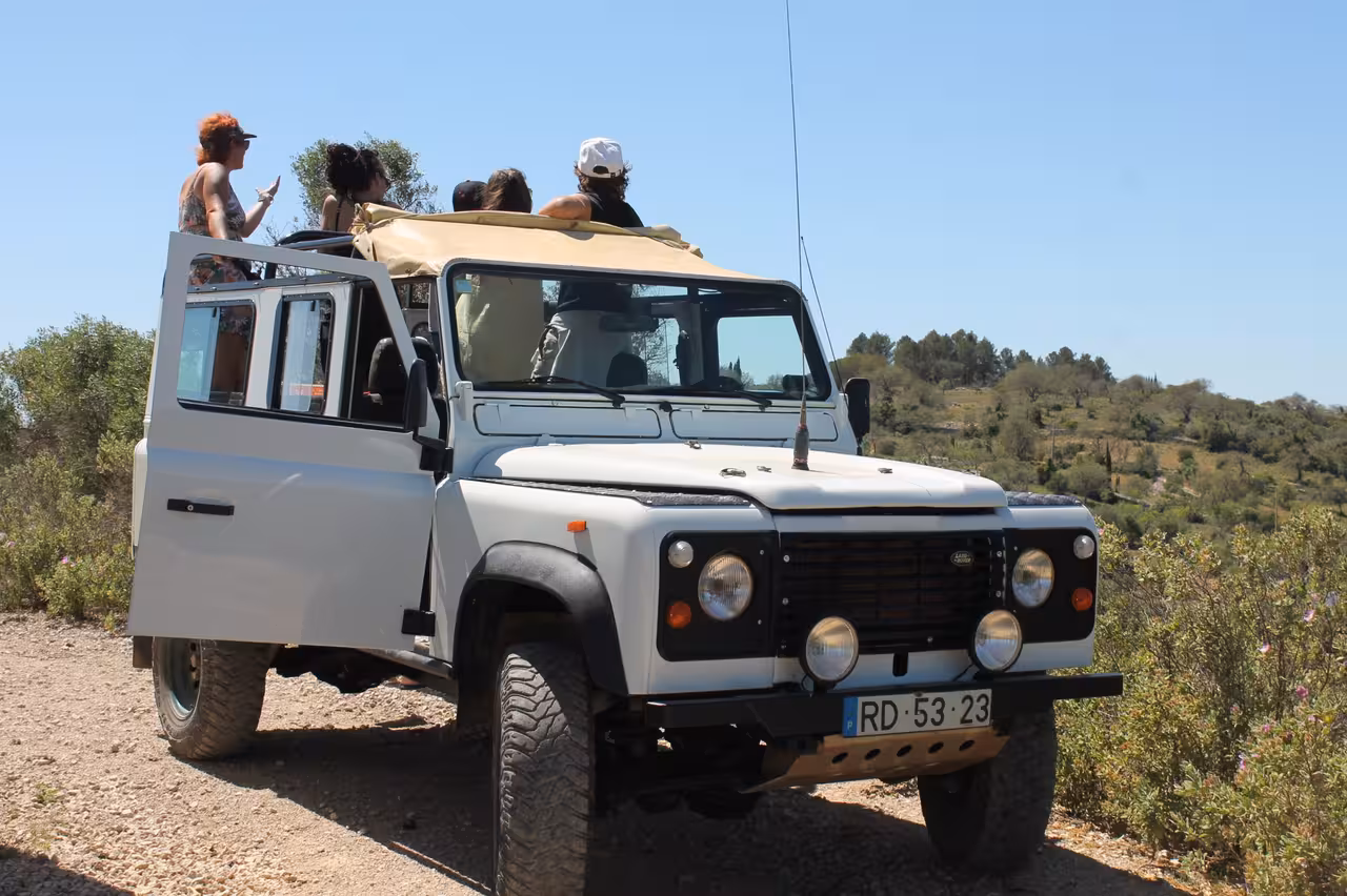 Open-top 4x4 with passengers on Jeep Zoofari, Algarve off-road safari through countryside viewpoints and trails
