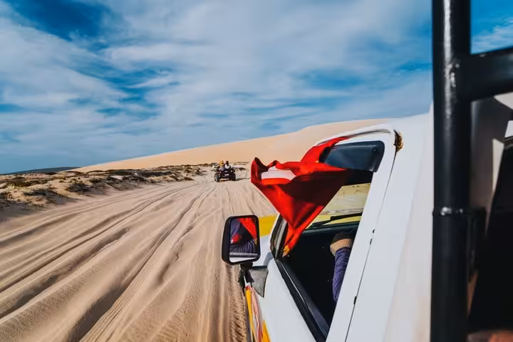 4x4 transfer from Jericoacoara Airport to hotels in Jericoacoara crossing dunes on sandy road in Ceará