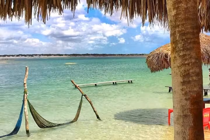 Hammock over crystal-clear lagoon at Jericoacoara, a relaxing stop on the East Coast tour in Ceará