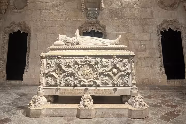 Intricately carved stone tomb in Jerónimos Monastery, a highlight of Belém's historical private tour.