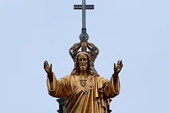 Golden statue of Jesus Christ with a crown at the Sanctuary of Fátima, a highlight of the day trip from Lisbon in small groups.