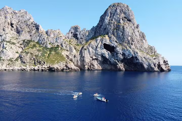 Aerial view of Es Vedrà Ibiza with jet skis and support boat on a San Antonio to Es Vedrà excursion