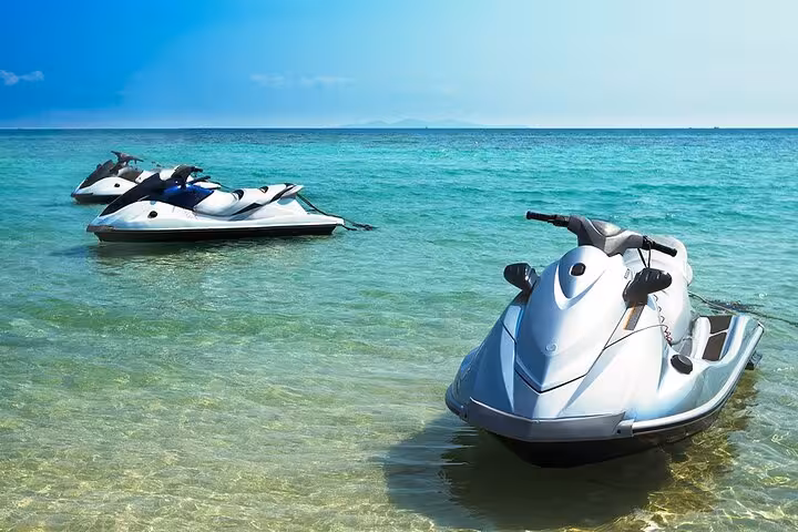 Jet skis floating in clear turquoise water, Dubai jet ski rental tour for 30-minute or 1-hour ride