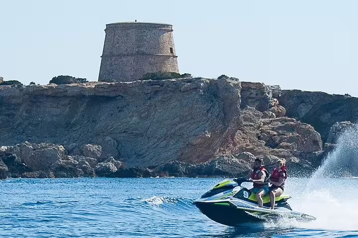 Two riders on a jet ski near Ibiza cliffs, part of San Antonio to Es Vedrá guided jet ski excursion
