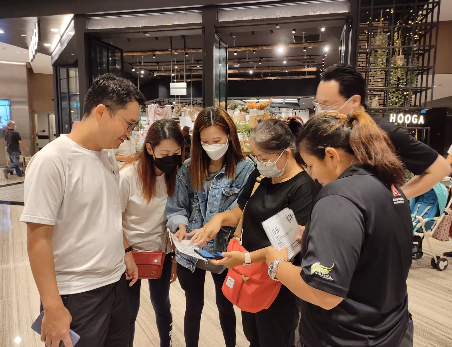 Visitors checking Jewel Changi Airport Canopy Park admission tickets inside terminal mall before entry