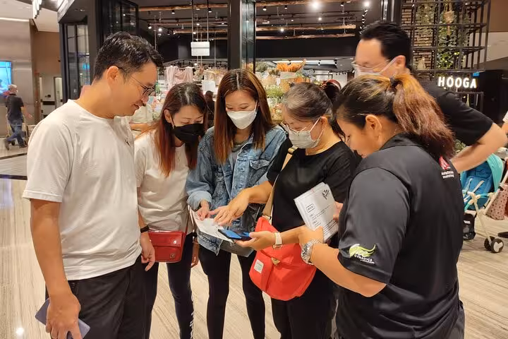 Visitors checking tickets at Jewel Changi Airport for Canopy Park admission, Singapore attraction entry