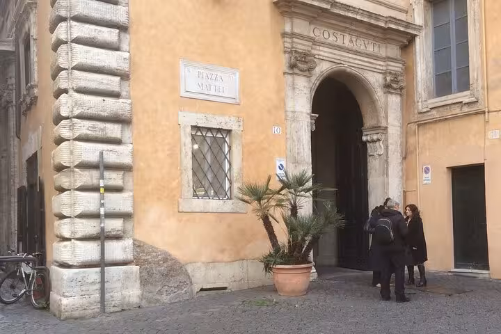 Visitors at Piazza Mattei in Rome's Jewish Ghetto, exploring historic sites on a guided Roman cuisine tour.