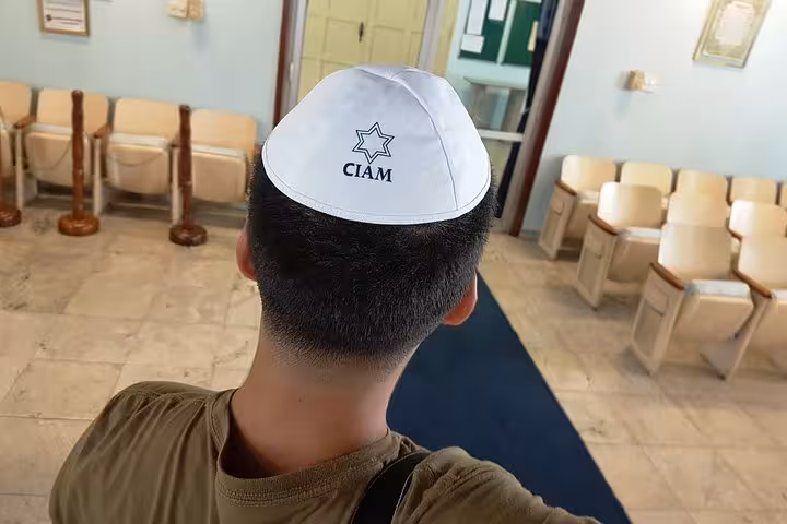 Traveler wearing a kippah inside a Manaus synagogue lobby during a Jewish heritage tour in the Amazon