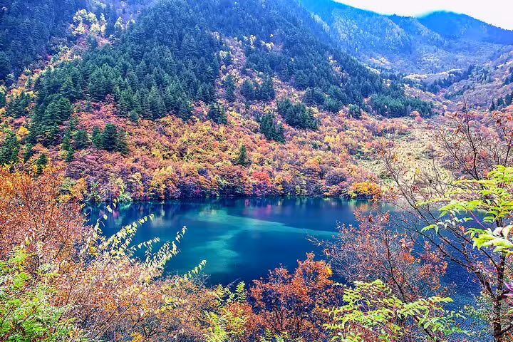 Autumn foliage and a serene blue lake in Jiuzhaigou, ideal for a three-day high-speed rail tour experience.