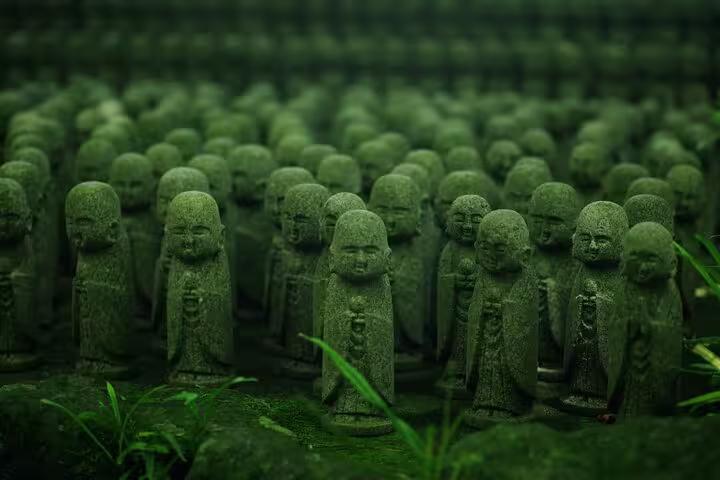 Rows of moss-covered Jizo statues in Kamakura, showcasing spiritual heritage on the Tokyo to Kamakura private tour.