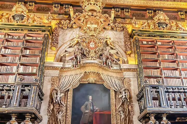 Opulent interior of the Joanina Library in Coimbra, showcasing ornate baroque architecture on a Lisbon to Tomar & Coimbra tour.