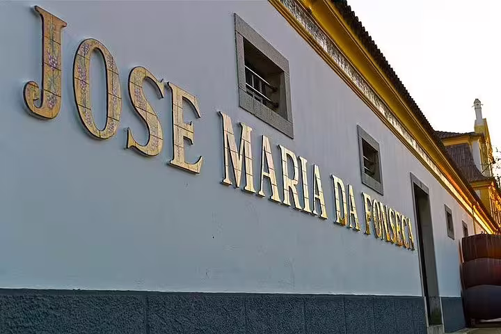 Exterior view of Jose Maria da Fonseca winery in Azeitao, showcasing its historic architecture during a wine tour.