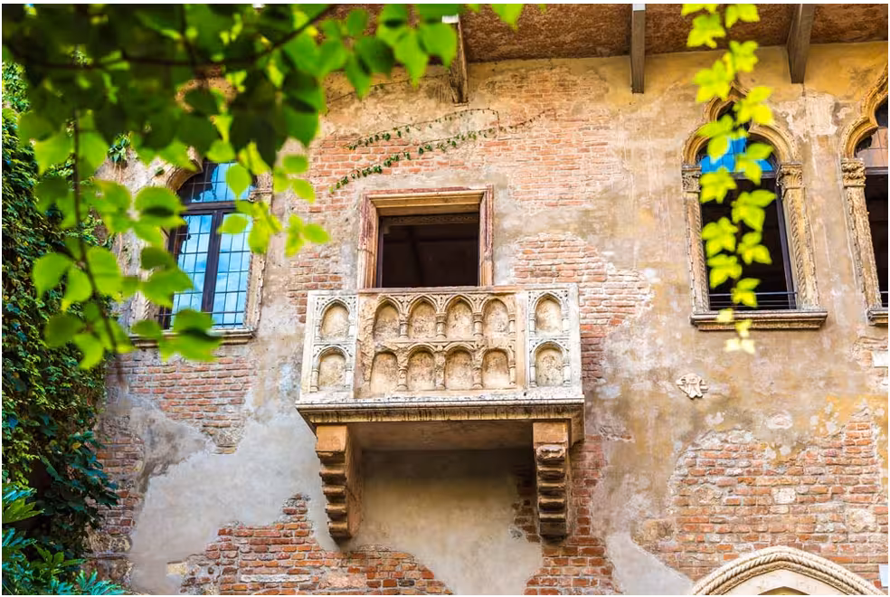 View of Juliet's famous balcony in Verona, highlighting its historic charm, part of the Milan day tour package.