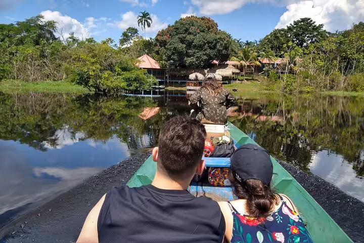 Boat transfer to Juma Lake Lodge on a 2 days 1 night Amazon tour, cruising calm river to rainforest cabins