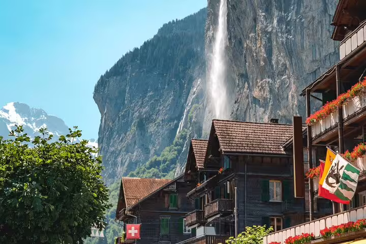 Charming Swiss village with Lauterbrunnen waterfall and alpine chalets on the Jungfraujoch private day trip.
