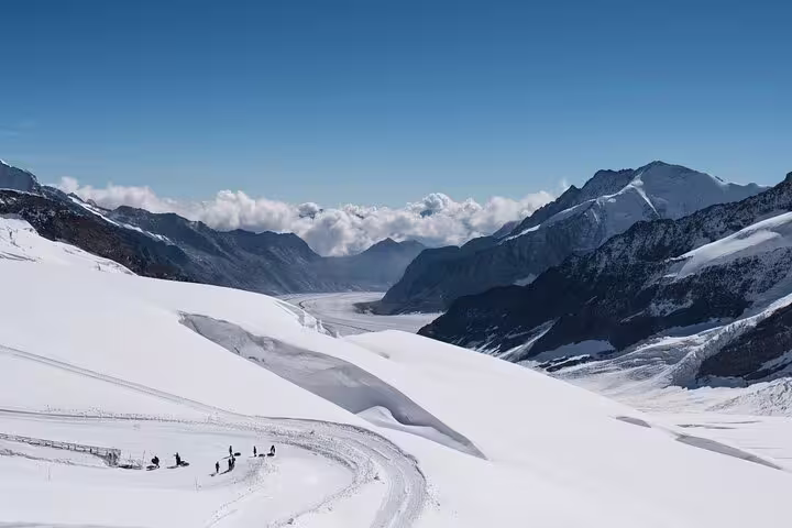 Breathtaking view of the snow-covered Alps on the Jungfraujoch Private Day Trip, showcasing pristine peaks and clear skies.