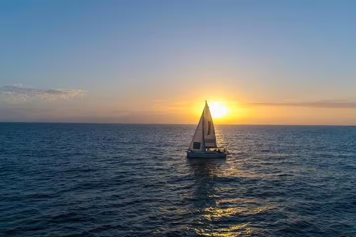 Sailing into the sunset on the Kailani Yacht, offering a breathtaking ocean view ideal for whale and dolphin tours.