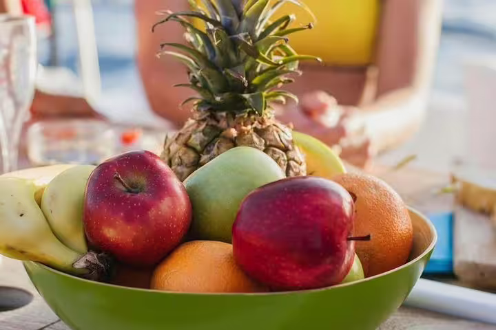 A vibrant bowl of tropical fruits on a sailing yacht, adding a fresh touch to the Kailani Sailing Yacht experience.