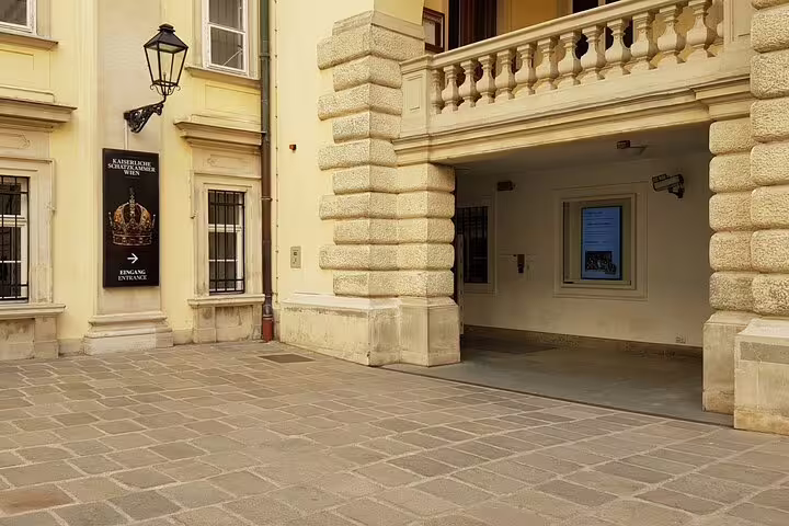 Entrance to the Kaiserliche Schatzkammer with signage, inviting visitors to explore the imperial treasures within.