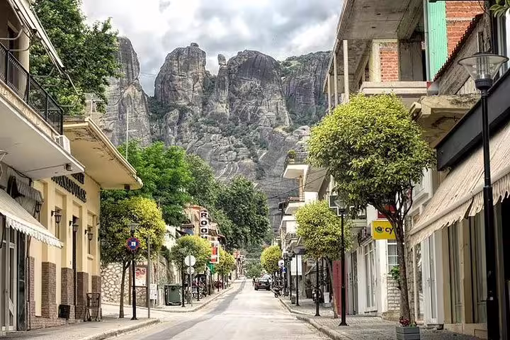 Kalambaka main street with Meteora rock pillars in the background on Delphi & Meteora 2-day tour