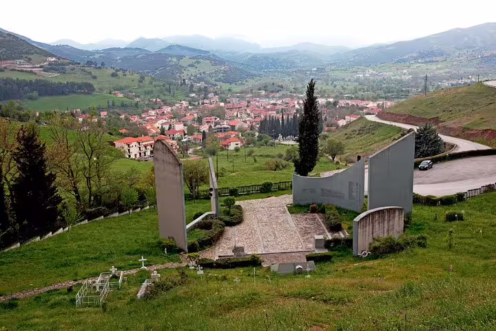 Kalavryta hillside memorial viewpoint overlooking the mountain town on a full-day tour from Athens
