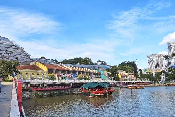 Bustling alley in Singapore's Kampong Glam with colorful shophouses and tourists capturing vibrant street scenes.