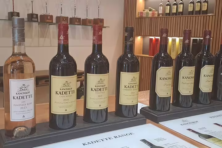 Display of Kanonkop Kadette wines in a Franschhoek tasting room, showcasing a variety of premium bottles.