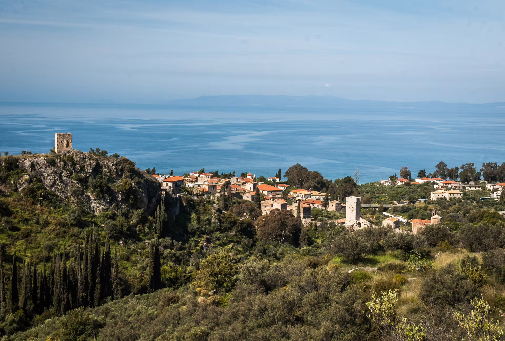 Panoramic Kardamyli hiking trail view, Mani Peninsula, with coastal village, cypress trees and blue sea