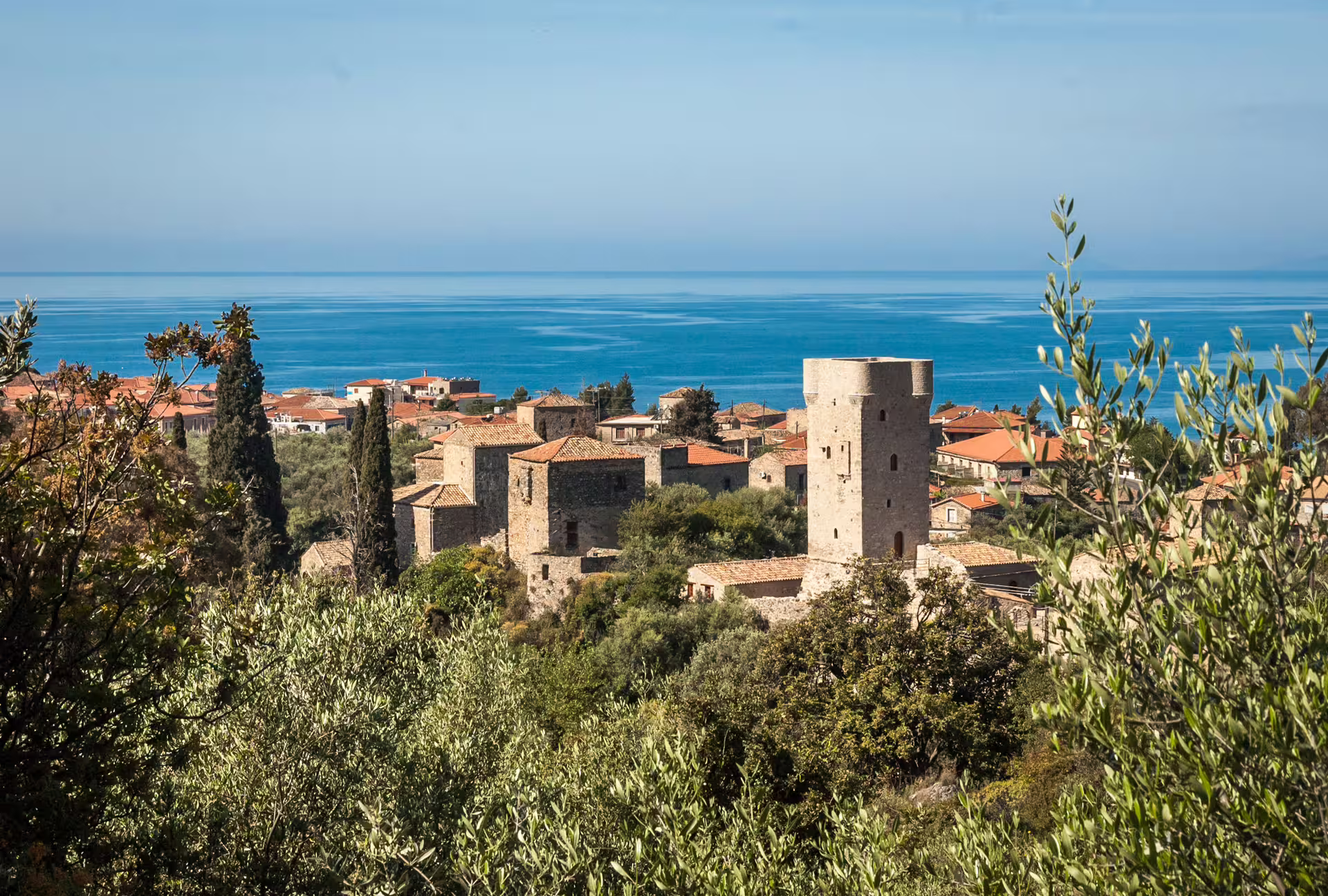 Sea-view hike above Kardamyli, Mani, with stone tower houses and olive groves on the Messinian Gulf