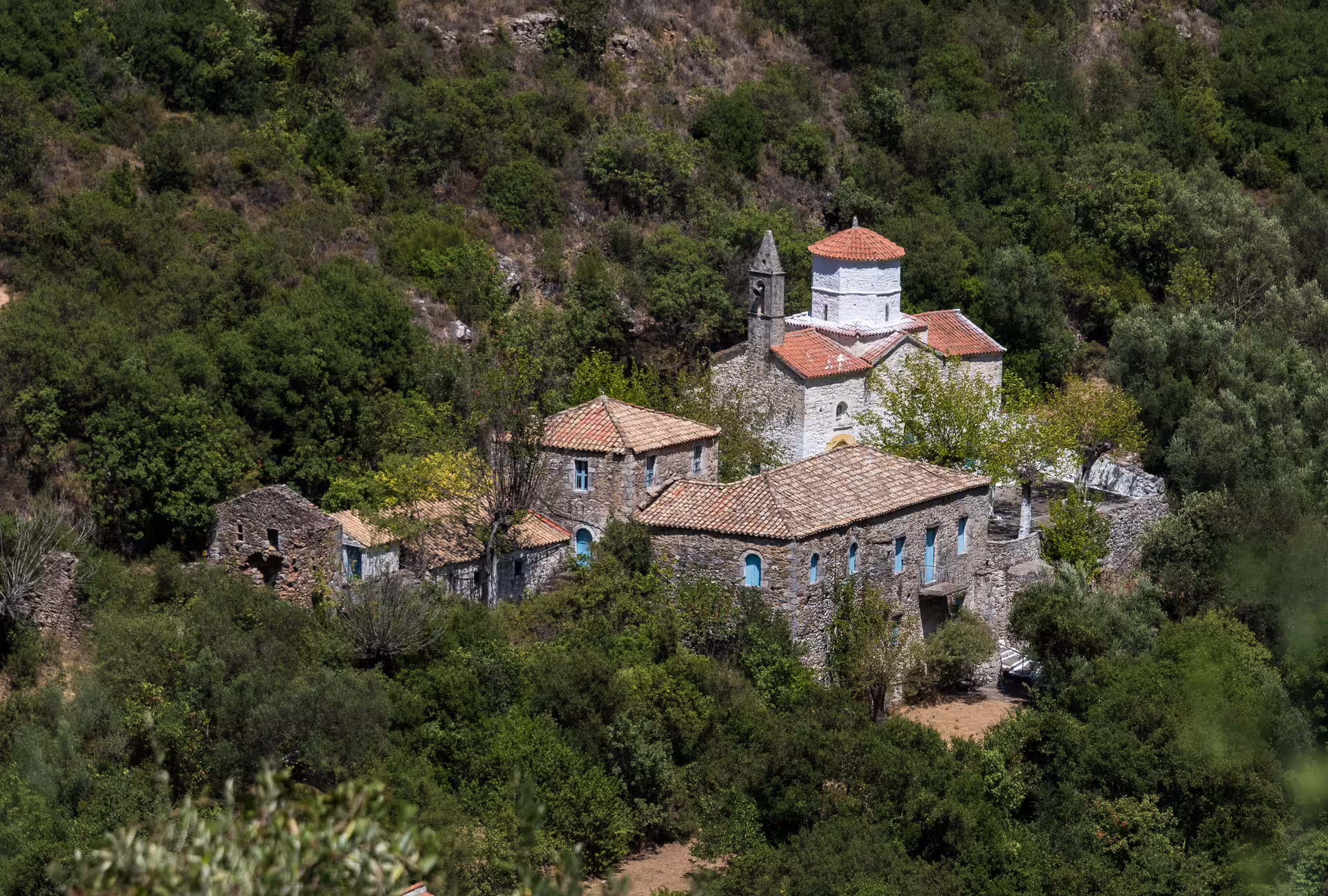Remote stone monastery and village in lush hills near Kardamyli, Mani Peninsula, Greece hiking tour view