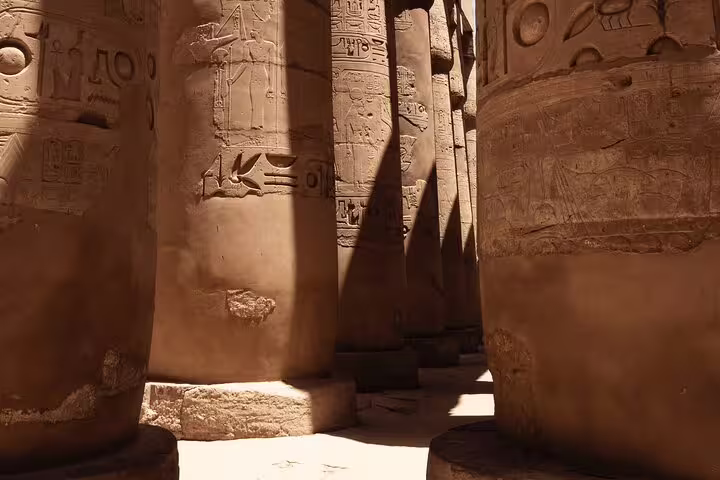 Karnak Temple hypostyle hall columns with hieroglyphs, visited on private Luxor day trip from Cairo