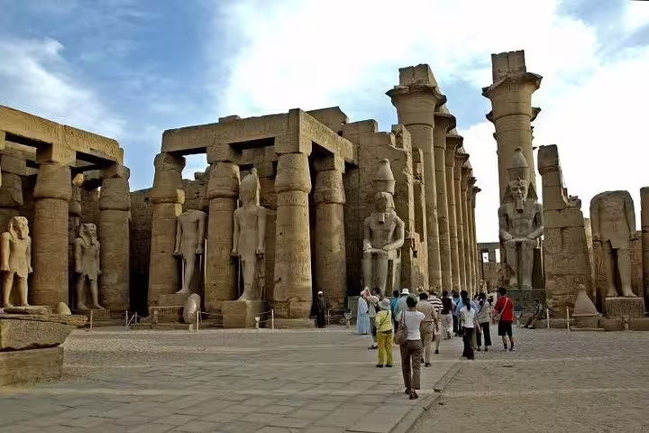 Travelers walking through Karnak Temple columns in Luxor, Egypt, on Aswan to Luxor Nile cruise itinerary