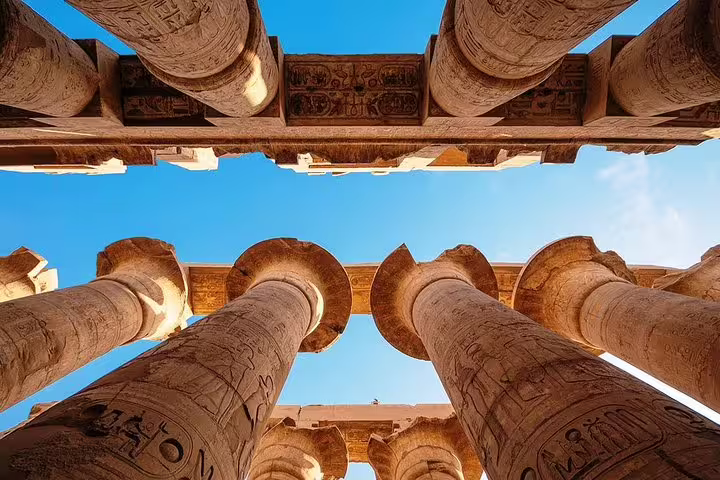 Upward view of carved columns at Karnak Temple, a must-see stop on the full-day Luxor highlights tour