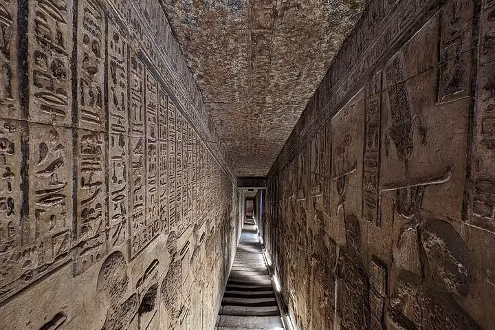Dimly lit corridor with intricate hieroglyphics in Karnak Temple, offering a glimpse into Egypt's ancient past.