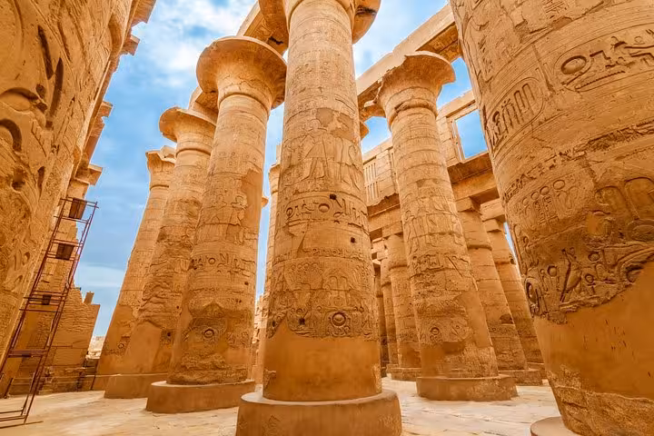 Towering carved columns inside Karnak Temple hypostyle hall, Luxor guided tour of ancient Egyptian ruins