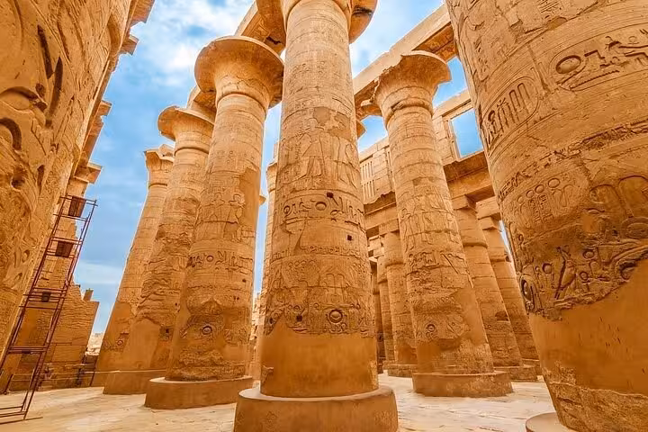 Intricately carved columns at Karnak Temple Hypostyle Hall showcase ancient Egyptian hieroglyphs and craftsmanship.