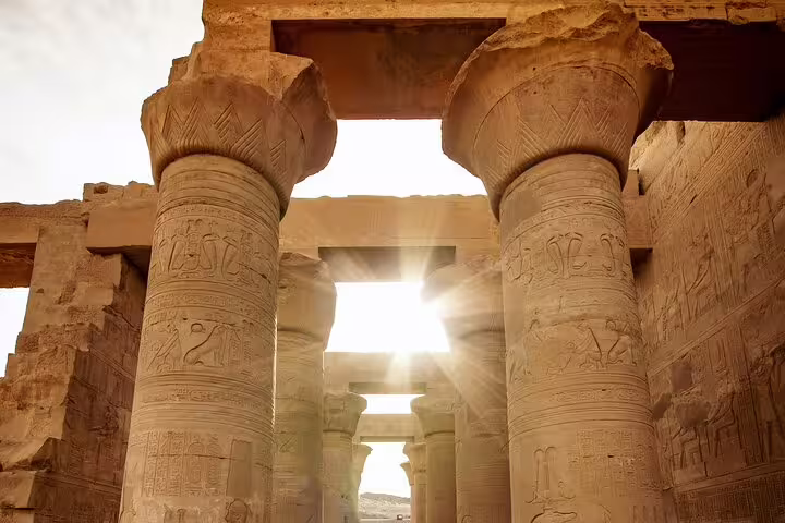Sunlit Karnak Temple columns with hieroglyphs on a private Luxor tour from Cairo by air, Egypt