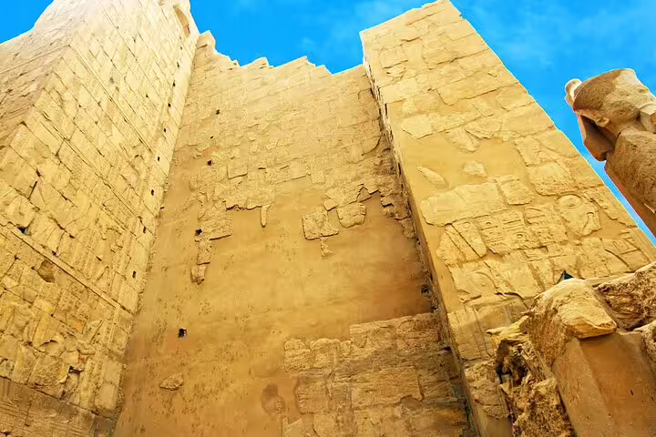 Towering Karnak Temple sandstone walls in Luxor, visited on a Cairo to Luxor day trip by plane