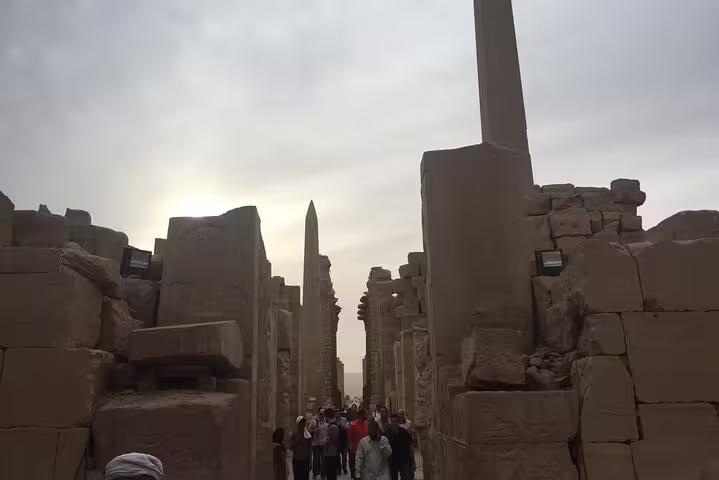 Karnak Temple avenue with towering columns and obelisk on a private Luxor day trip from Hurghada