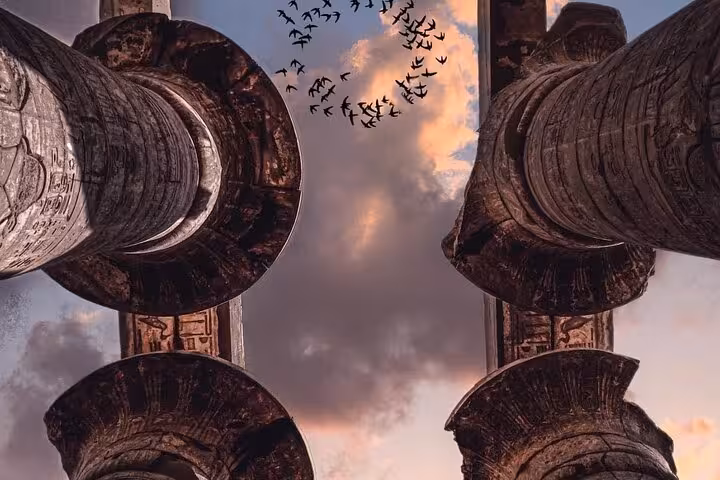 Looking up at Karnak Temple columns at sunset, a highlight stop on a private Luxor horse carriage experience