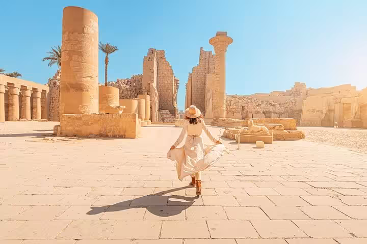 Traveler exploring Karnak Temple ruins in Luxor on 2-day Hurghada tour with hotel stay and Nile cruise