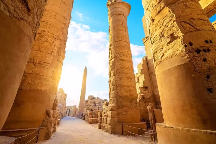 Karnak Temple avenue with towering columns and Luxor obelisk on full-day semi-private tour from Marsa Alam