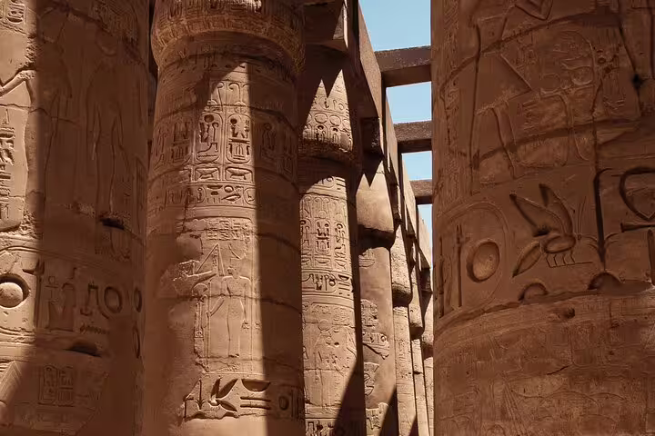 Karnak Temple hypostyle hall columns with hieroglyphs, Luxor sightseeing on Cairo to Luxor VIP train package