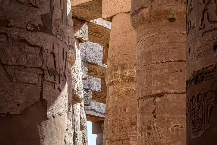Karnak Temple columns with carved hieroglyphs in Luxor, a highlight of the 3 days 2 nights tour from Cairo by VIP train