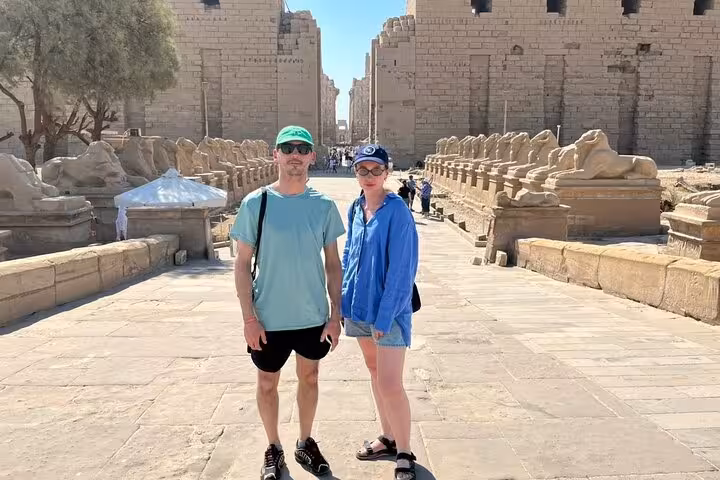 Visitors on Karnak Temple sphinx avenue in Luxor, part of 2-day Hurghada tour with hotel and guided visits